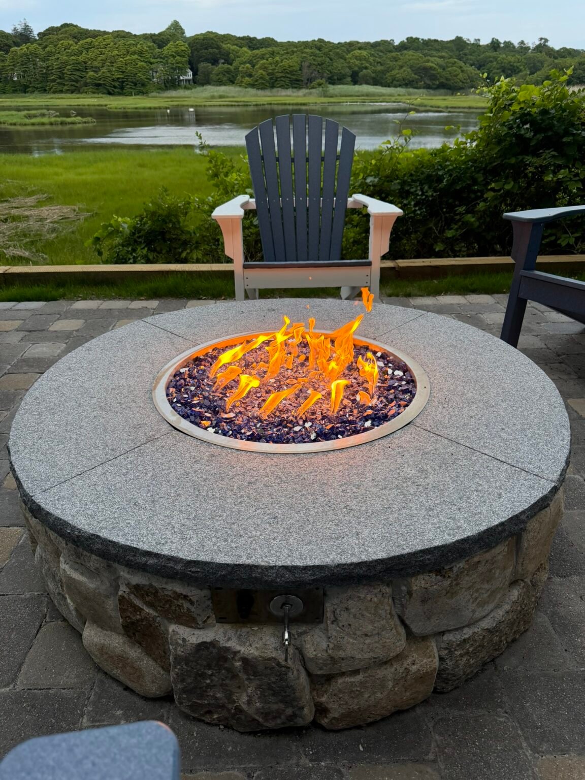 Natural stone fire pit installed on a Cape Cod patio