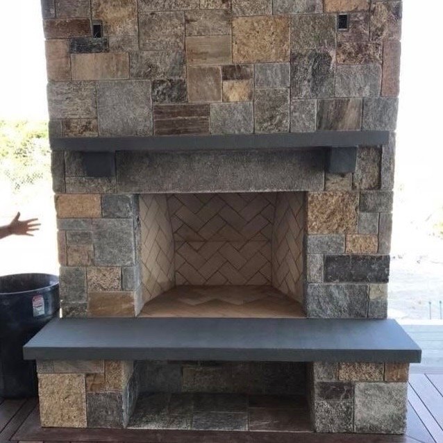 Stone fireplace with herringbone firebox built by Bridi Masonry in Cape Cod, MA