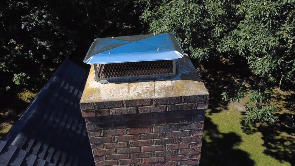New stainless chimney cap installed over a repaired crown on Cape Cod