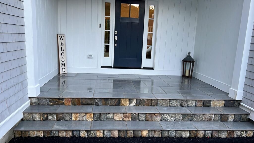 Bluestone front steps with stacked stone risers built by Bridi Masonry in Cape Cod, MA