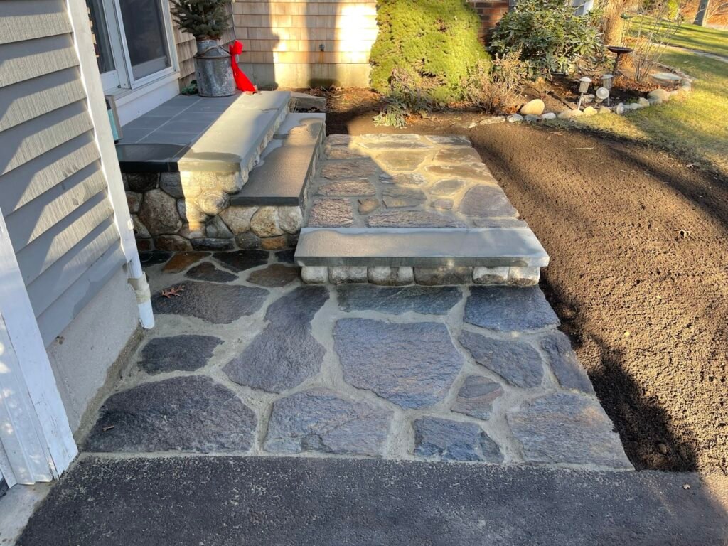Irregular bluestone walkway and steps built by Bridi Masonry in Cape Cod, MA