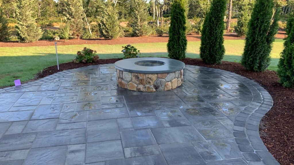Bluestone patio with fire pit built by Bridi Masonry in Cape Cod, MA