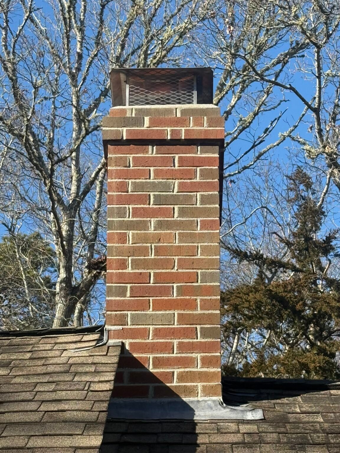 After: new brick chimney with clean mortar joints, Cape Cod