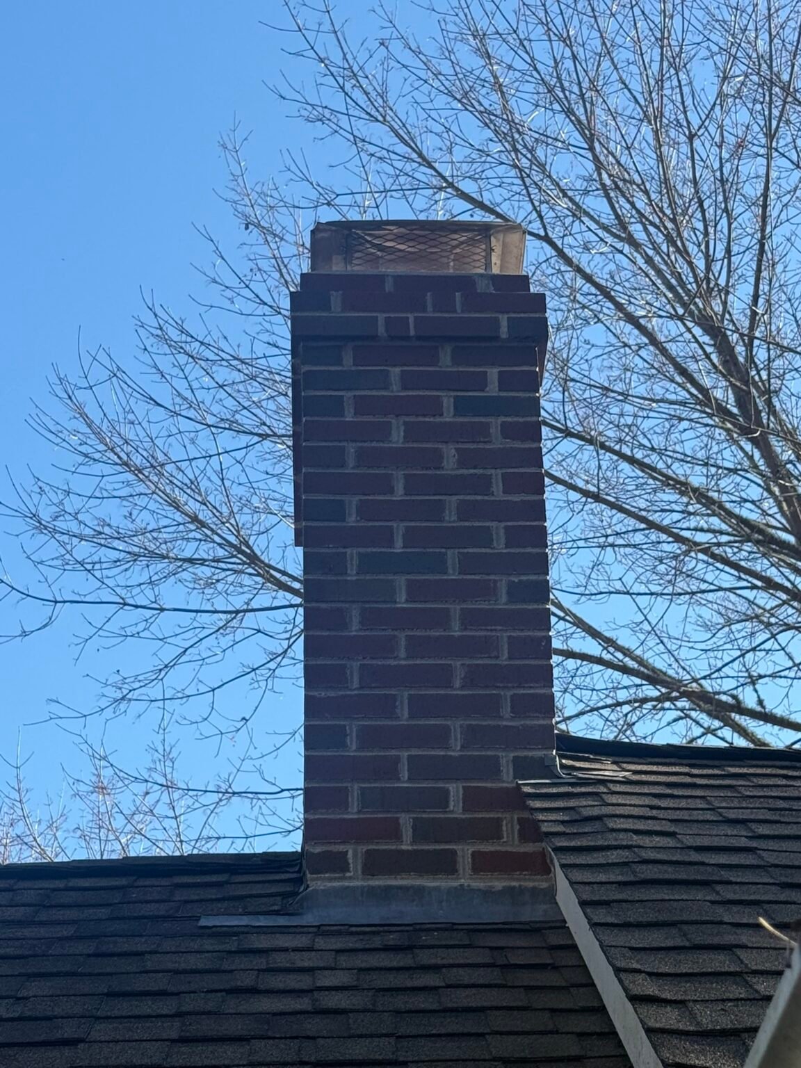 After: rebuilt brick chimney with a new crown and cap on Cape Cod