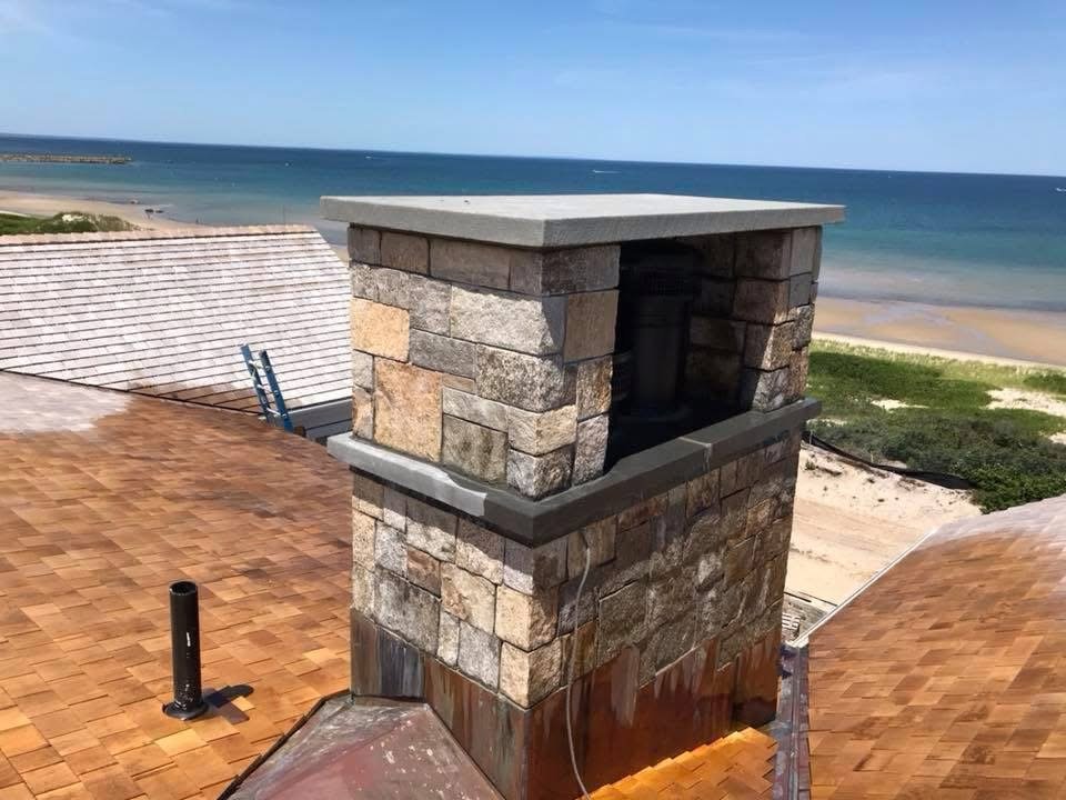 Stone chimney overlooking the beach built by Bridi Masonry in Cape Cod, MA