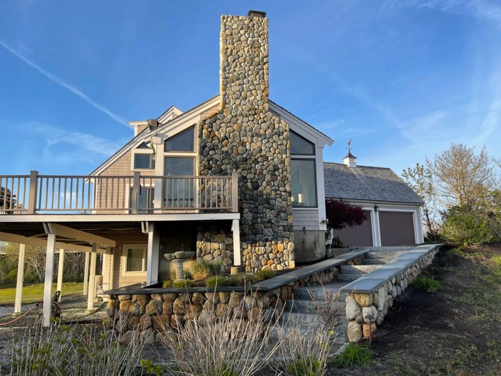 Stone chimney and retaining wall built by Bridi Masonry in Cape Cod, MA