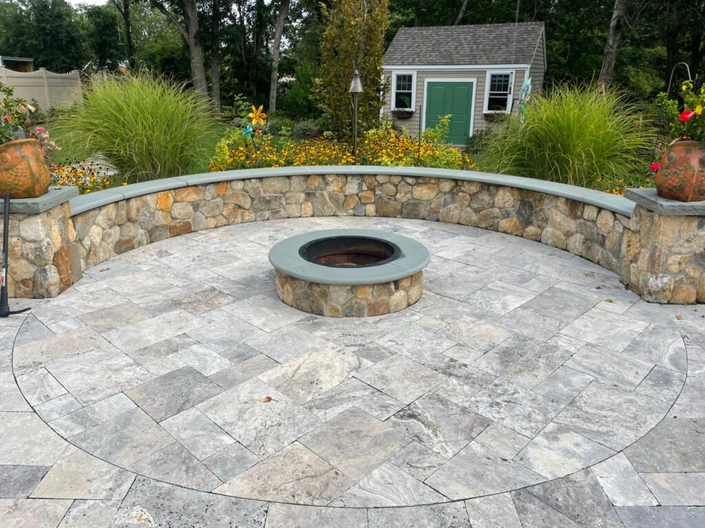 Travertine patio with fire pit built by Bridi Masonry in Cape Cod, MA