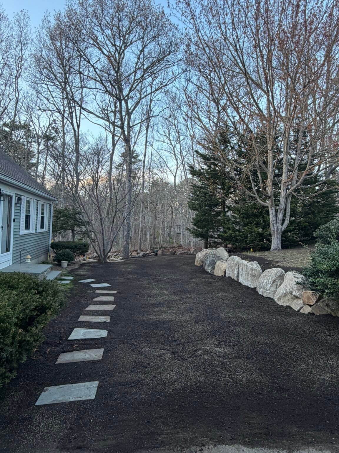 Stone steppers and boulder wall built by Bridi Masonry in Cape Cod, MA