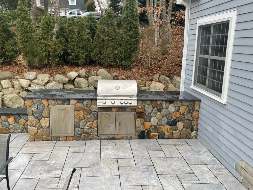 Outdoor kitchen with stone veneer built by Bridi Masonry in Cape Cod, MA