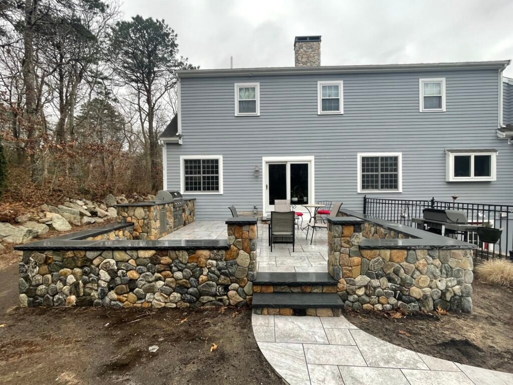 Stone retaining wall and patio built by Bridi Masonry in Cape Cod, MA