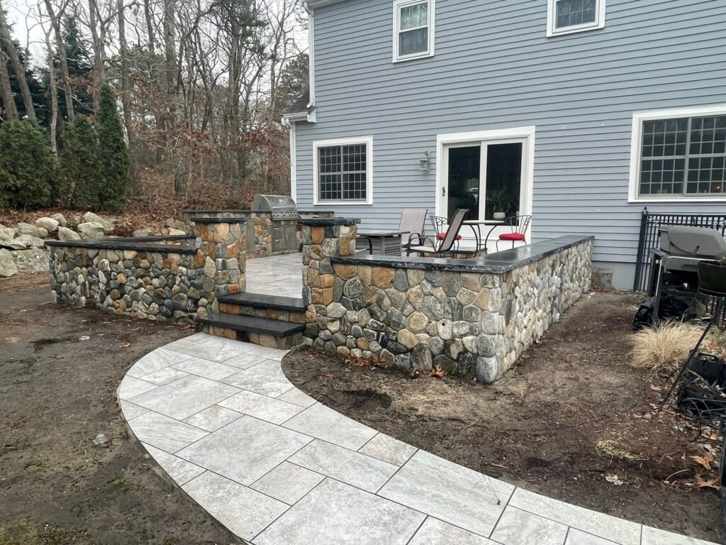 Outdoor kitchen and retaining wall built by Bridi Masonry in Cape Cod, MA
