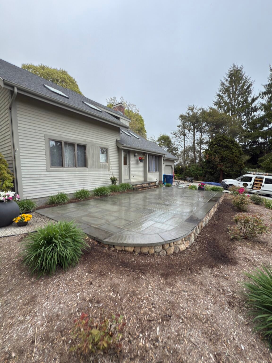 Bluestone patio with stone wall built by Bridi Masonry in Cape Cod, MA