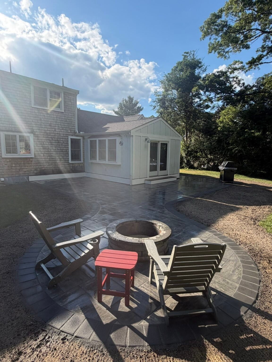 Paver patio with fire pit built by Bridi Masonry in Cape Cod, MA