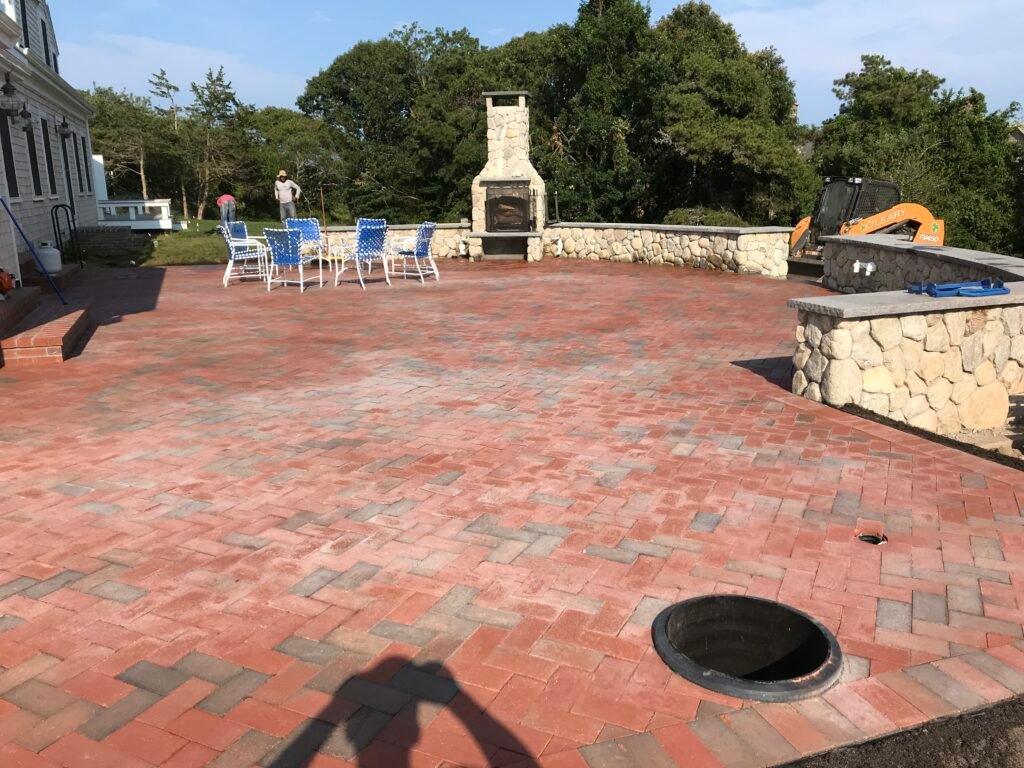 Brick patio with outdoor fireplace built by Bridi Masonry in Cape Cod, MA