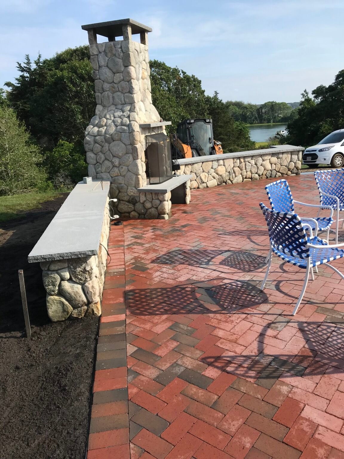 Brick patio with outdoor fireplace built by Bridi Masonry in Cape Cod, MA