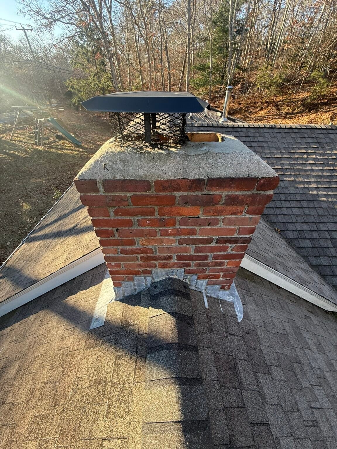 Before: chimney with a failed crown and an open gap beside the flue