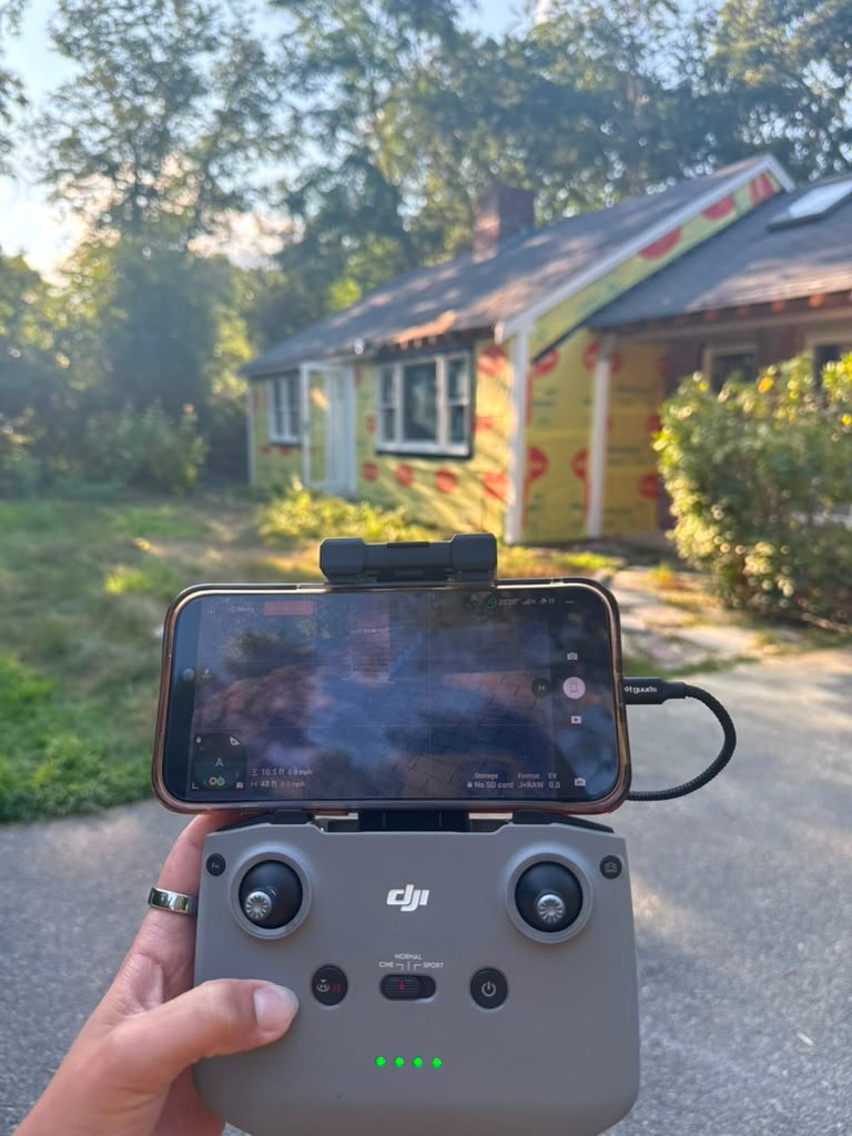 Bridi Masonry flying a drone to inspect a chimney on Cape Cod, live view on the controller