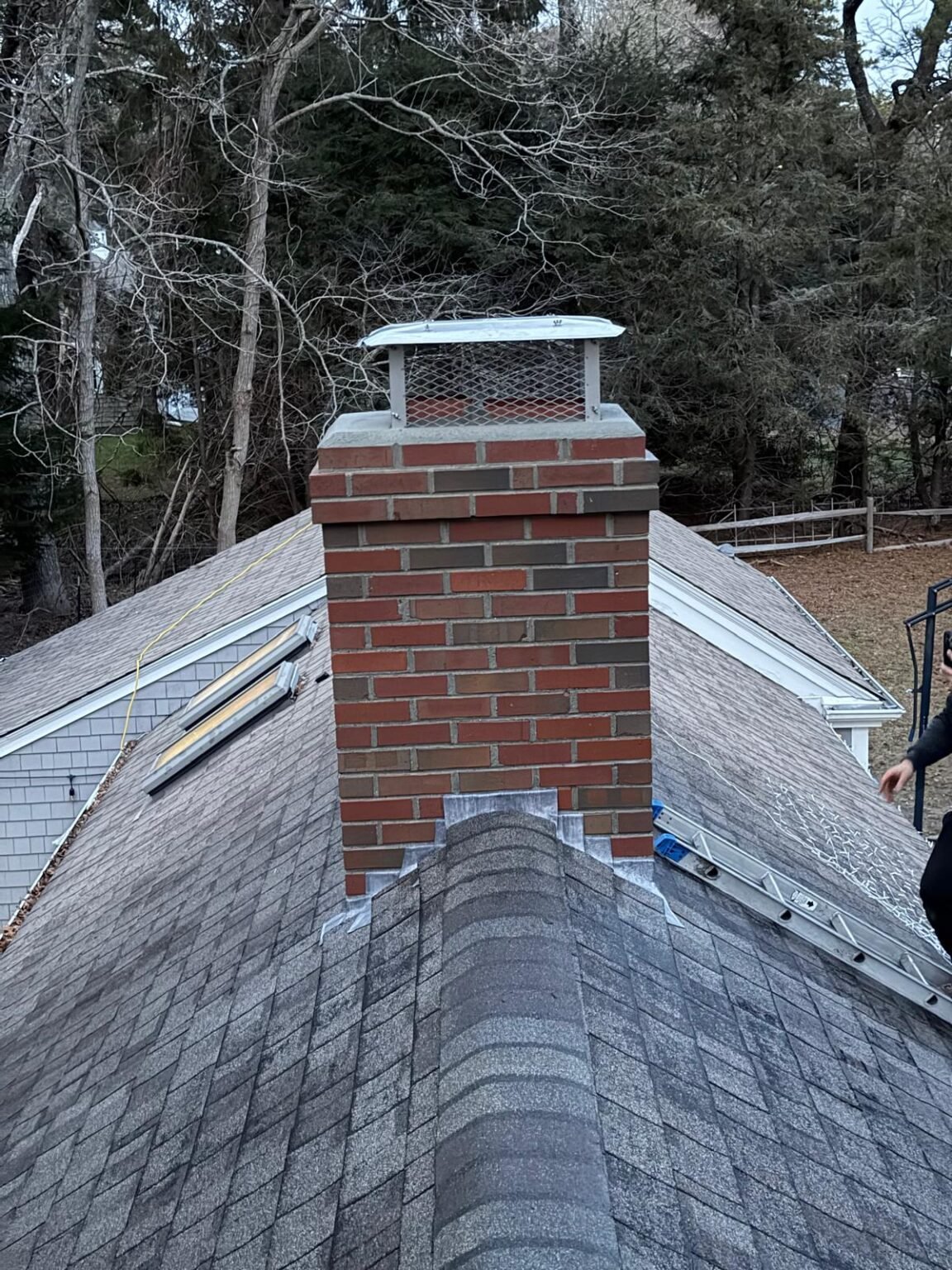 After: finished chimney rebuild on the roof ridge, Cape Cod