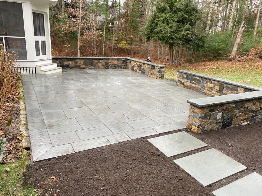 Bluestone patio with seat wall built by Bridi Masonry in Cape Cod, MA